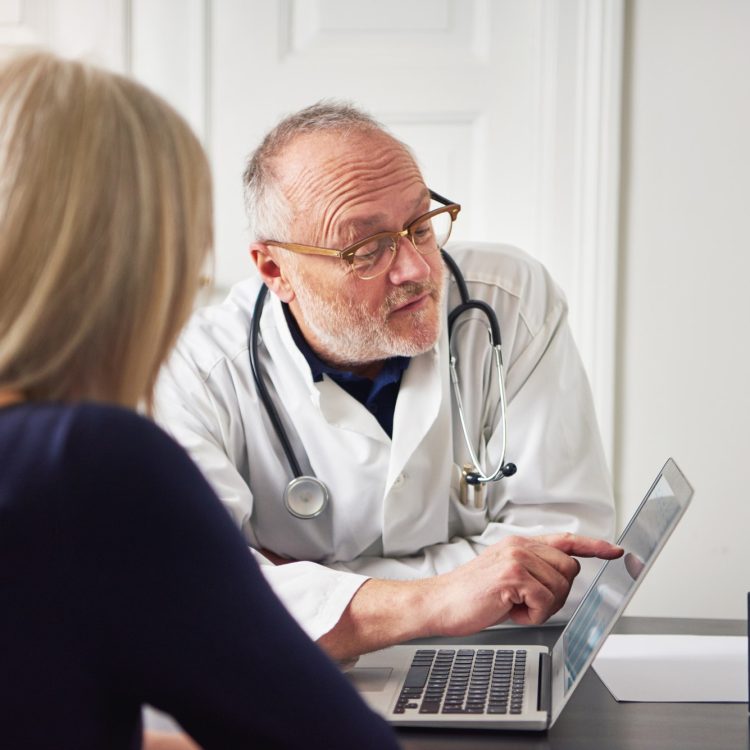 Woman having consultation with doctor at laptop